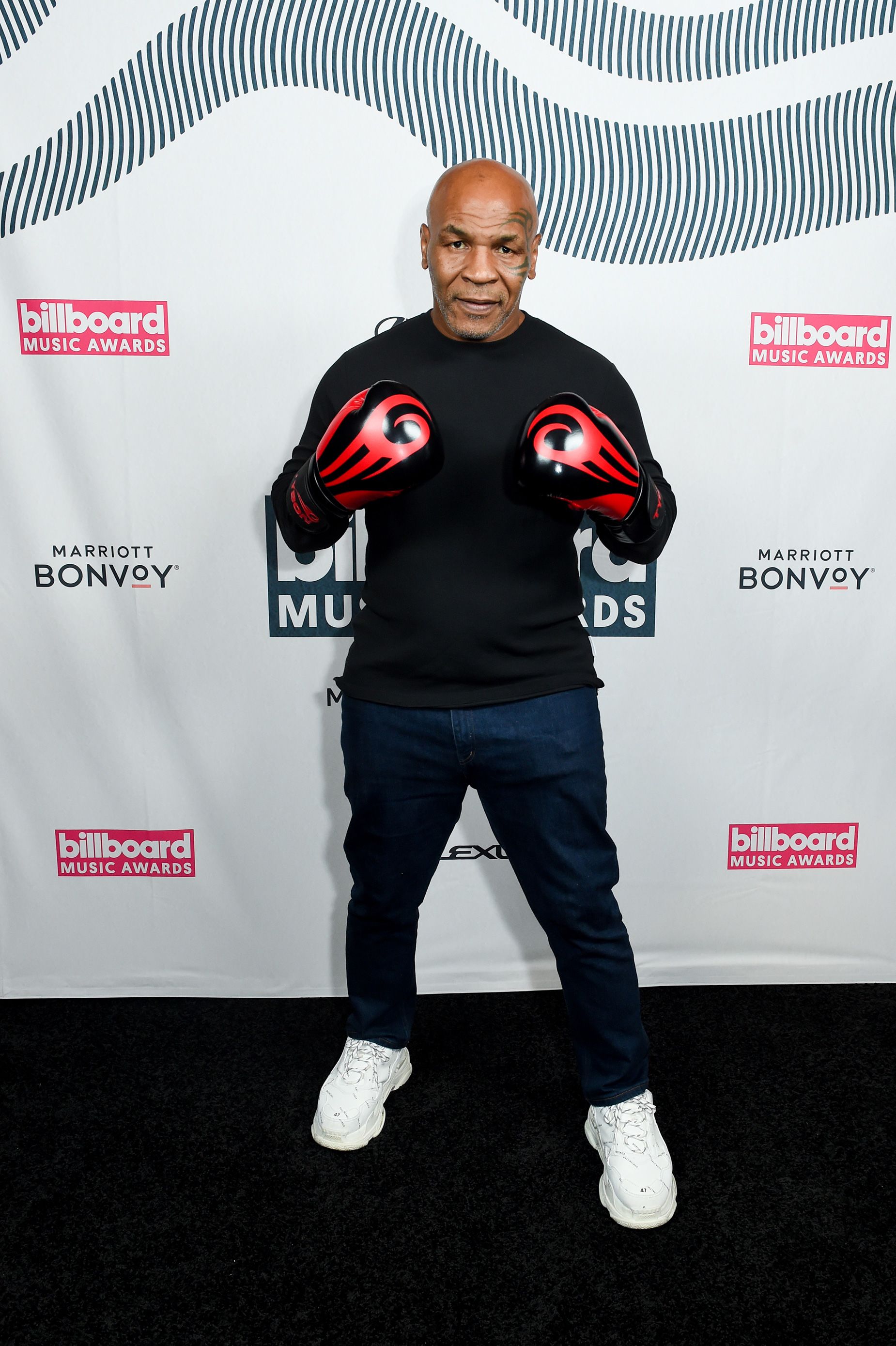 Knockout! Boxer Mike Tyson accessorized his casual look with a pair of red and black boxing gloves from his own line.