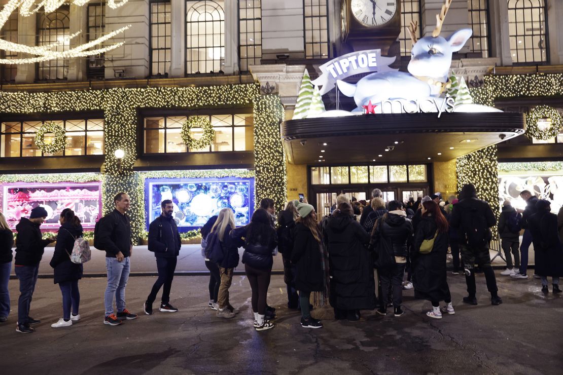 Customers wait in line before the store opens for early morning Black Friday sales outside Macy's Herald Square on November 24, 2023 in New York, New York.