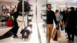 Shoppers look at clothes while others walk around Twelve Oaks Mall on November 24, 2023 in Novi, Michigan. The National Retail Federation projects that an estimated 182 million are planning to shop in-stores and online through the five-day Thanksgiving weekend.