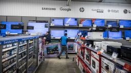 A worker stocks televisions at a Walmart store on Black Friday in Secaucus, New Jersey, US, on Friday, Nov. 24, 2023.