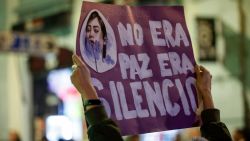 A demonstrator holds a sign reading "It was not peace, it was silence" during a demonstration called on the International Day for the Elimination of Violence against Women, in Madrid, on November 25, 2023. (Photo by OSCAR DEL POZO / AFP) (Photo by OSCAR DEL POZO/AFP via Getty Images)