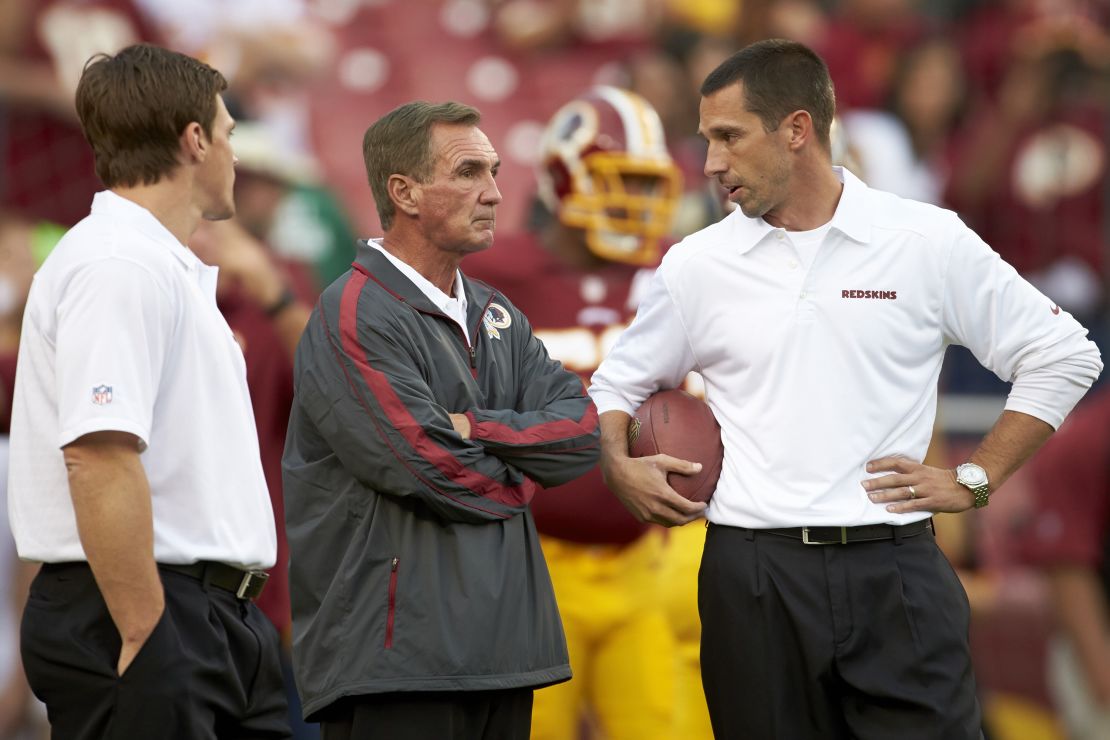 Washington Redskins coach Mike Shanahan with offensive coordinator and son Kyle Shanahan (right) during a game against the Philadelphia Eagles in 2013.