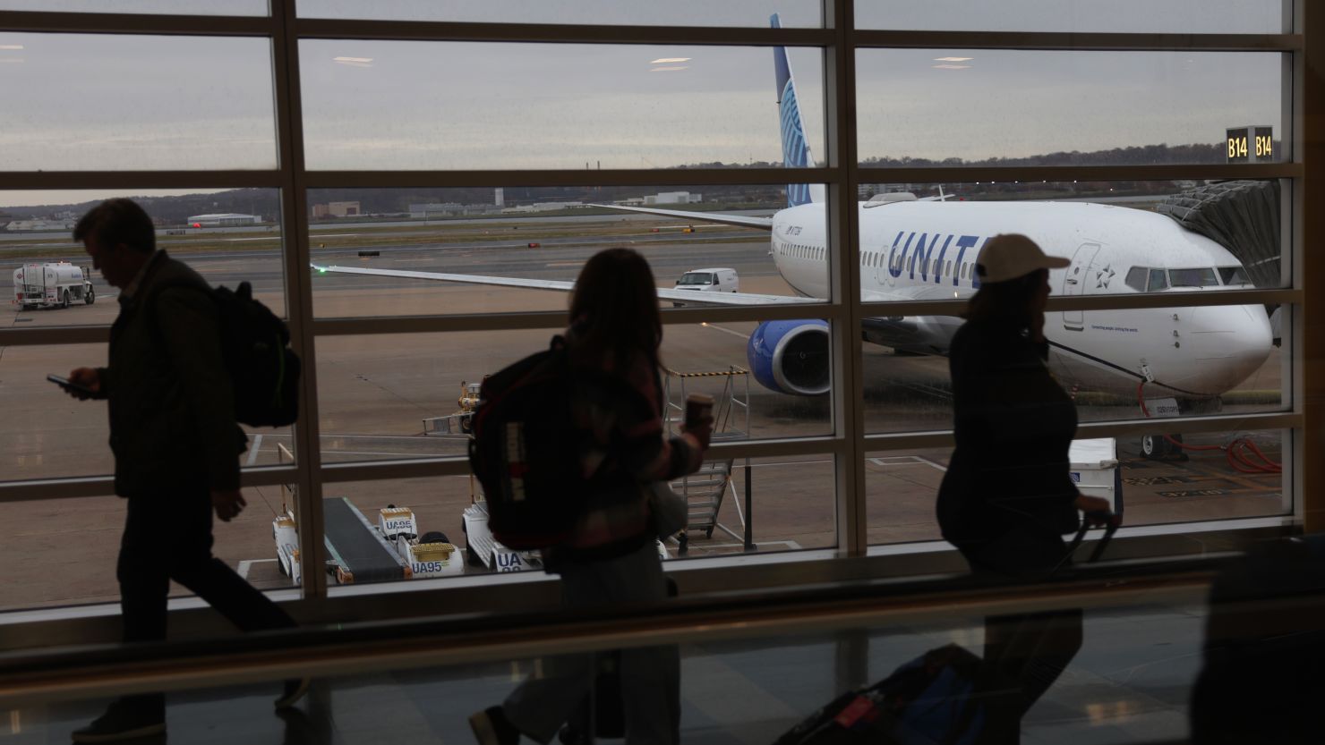 Passengers pass through a hallway at Ronald Reagan Washington National Airport on November 21, 2023 in Arlington, Virginia.