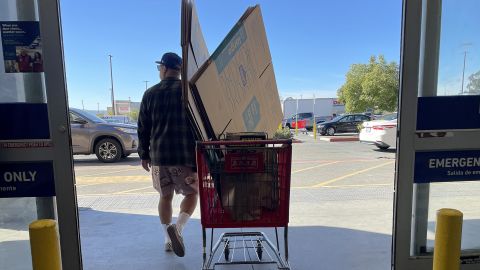 A customer pulls a shopping cart as he leaves a Lowe's store on November 21, 2023 in Pacoima, California.
