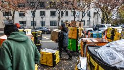 Amazon workers deliver packages on Cyber Monday in New York, US, on Monday, Nov. 27, 2023. An estimated 182 million people are planning to shop from Thanksgiving Day through Cyber Monday, the most since 2017, according to the National Retail Federation.