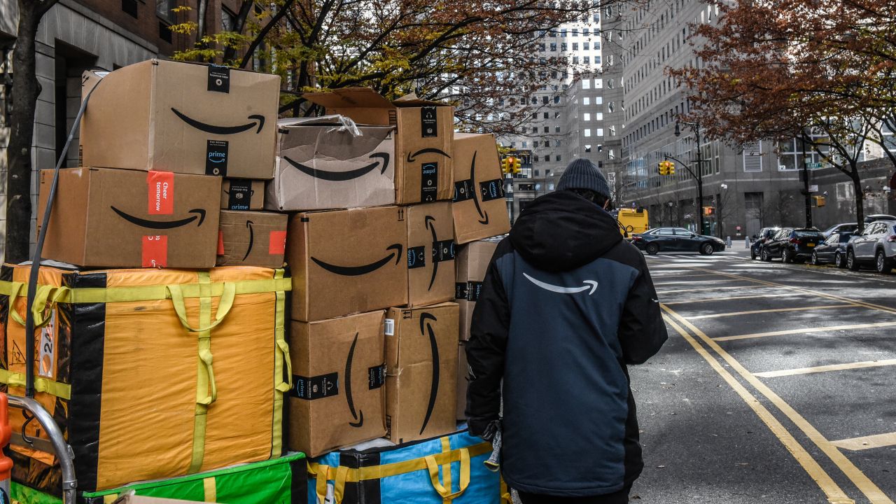 An Amazon worker delivers packages on Cyber Monday in New York, US, on Monday, Nov. 27, 2023.