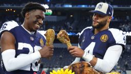 ARLINGTON, TEXAS - NOVEMBER 23: DaRon Bland #26 Dak Prescott #4 of the Dallas Cowboys take a bite out of a turkey leg after a win over the Washington Commanders at AT&T Stadium on November 23, 2023 in Arlington, Texas. (Photo by Richard Rodriguez/Getty Images)