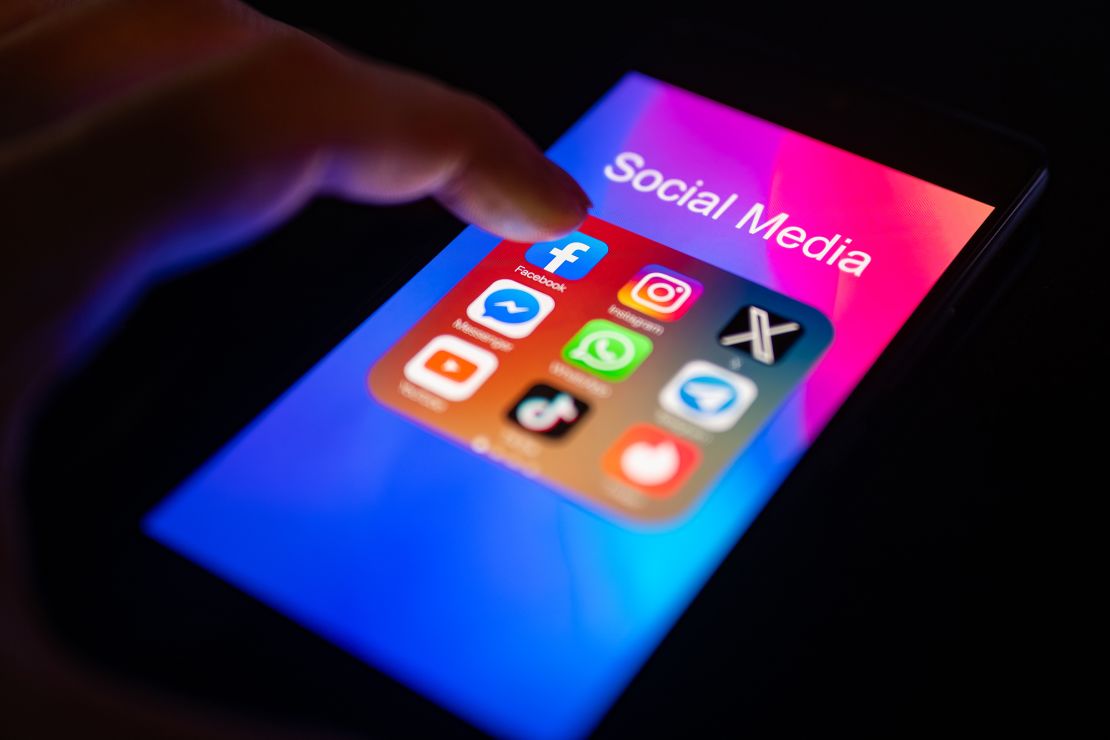A close-up of a finger is pointing to the Facebook mobile app on a smartphone screen, which is displayed alongside other apps including Instagram, WhatsApp, Telegram, TikTok, Tinder, YouTube, and Messenger, in Brussels, Belgium, on November 30, 2023.