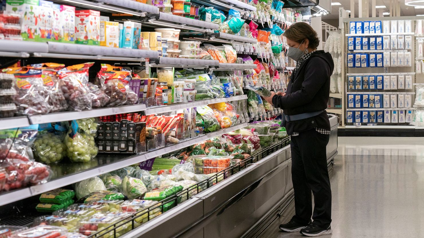 A customer selects goods at a supermarket in San Mateo, California, on November 29, 2023.