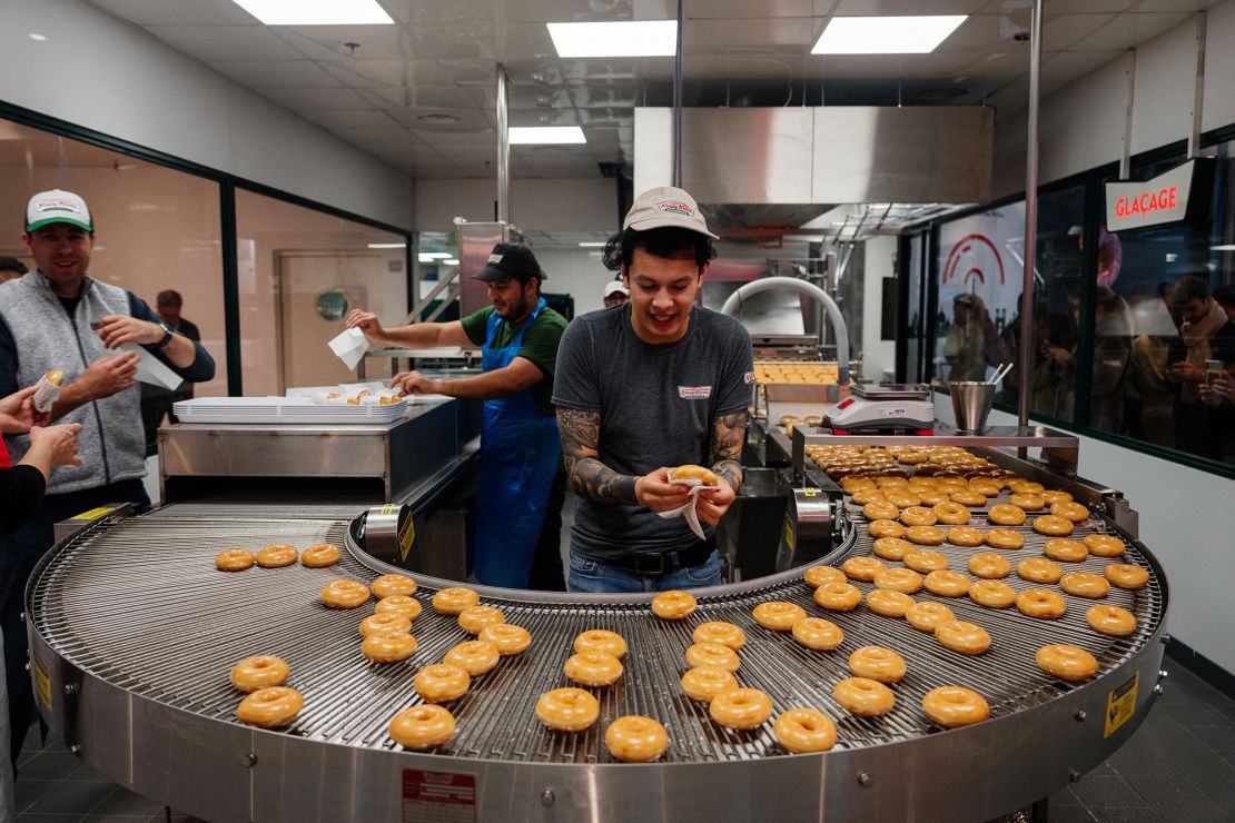 Krispy Kreme workers prepare donuts in the firm's first store in France on December 4.