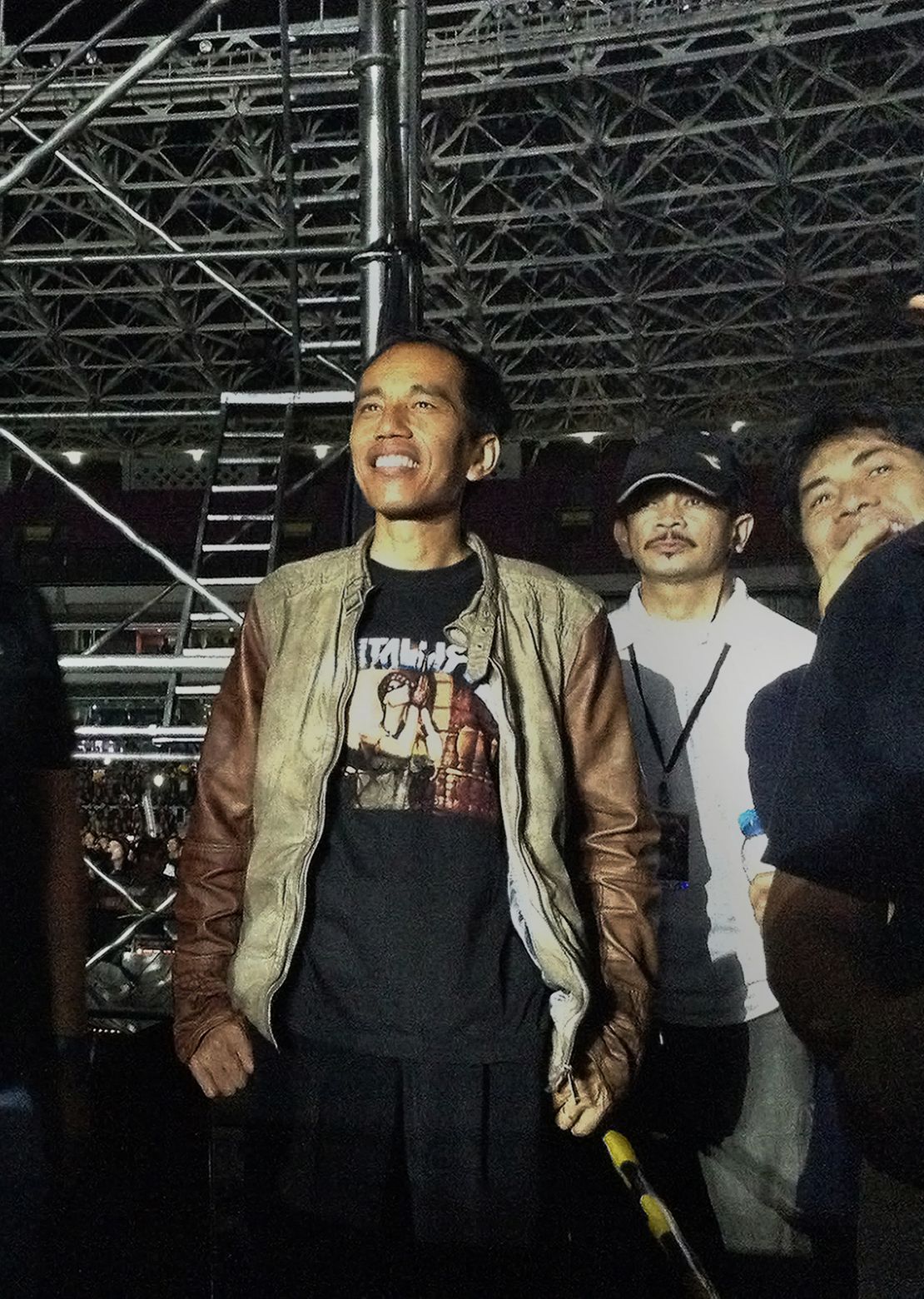 In this photograph taken on August 25, 2013, then-Jakarta governor Joko Widodo, watches a Metallica concert at the Bung Karno stadium in Jakarta.