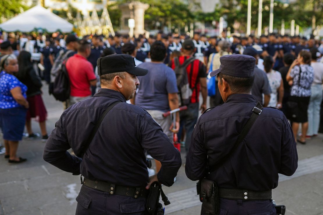 Police officers stand guard in the center of San Salvador on December 3, 2023.