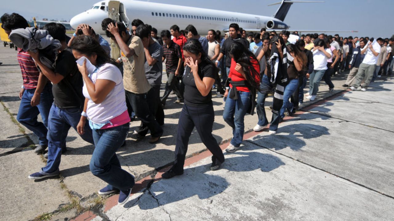 Guatemalan illegal immigrants deported from the United States wait walk along the tarmac upon their arrival back to Guatemala on November 7, 2008 in Guatemala City. Guatemala's President Alvaro Colom hopes that the dossier about migration moves forward during the administration of recently elected United States President, Barack Obama, in view of the increasing number of deportations. In 2008, more than 24,000 Guatemalans have been deported. AFP PHOTO/Eitan Abramovich (Photo by EITAN ABRAMOVICH / AFP) (Photo by EITAN ABRAMOVICH/AFP via Getty Images)