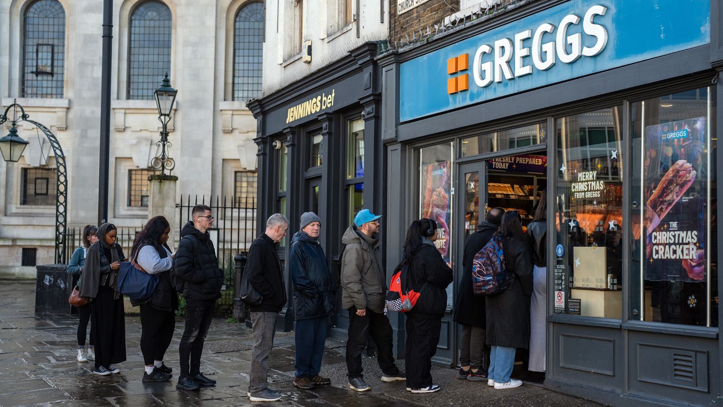 People queue outside Greggs in December 2023 in London.