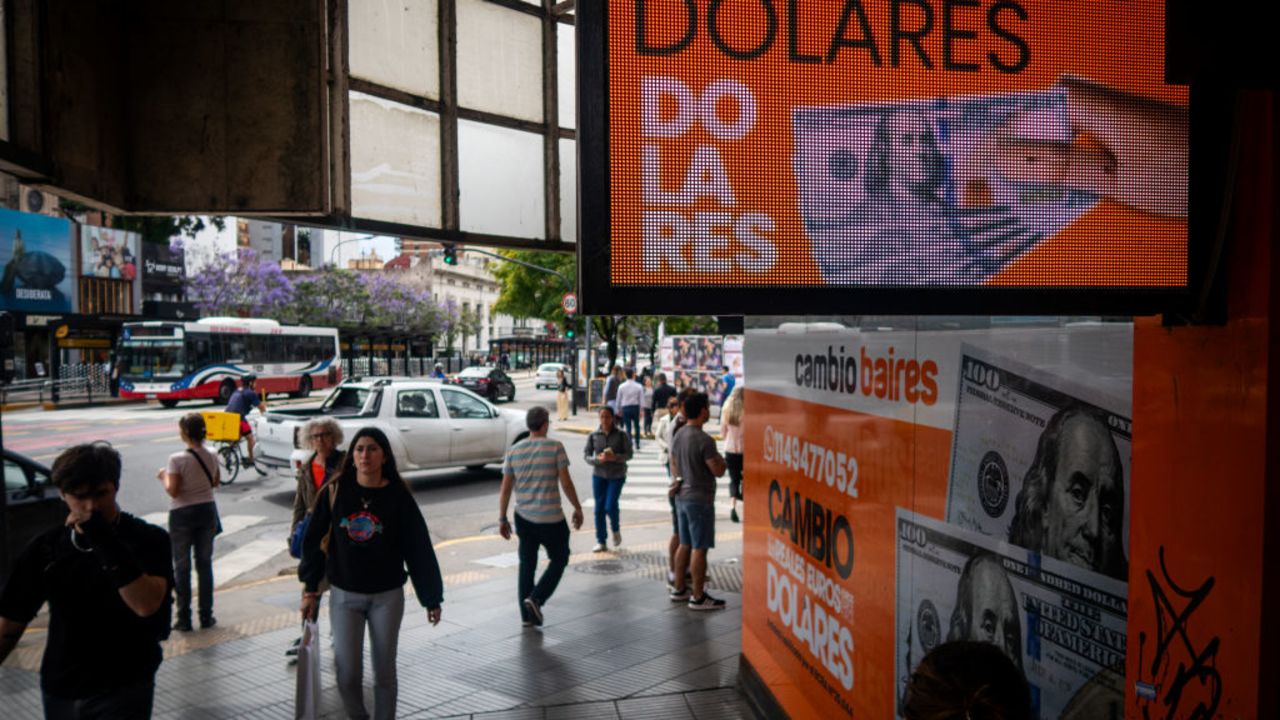 BUENOS AIRES, ARGENTINA - DECEMBER 04: Pedestrians walk by a currency exchange house on December 04, 2023 in Buenos Aires, Argentina. President-elect Javier Milei of La Libertad Avanza will take office on Sunday 10, replacing incumbent peronist Alberto Fernandez. Milei is a self-described "anarcho-capitalist" libertarian who wants to sharply reduce the size of the State and replace the local peso with the American dollar. During the campaign, he promised to uproot Argentina's political establishment and to align the economy with dramatic measures such as closing the Central Bank. After defeating the current Minister of Economy Sergio Massa in the run-off with 55,65% of the votes, the president-elect has shown moderation and pragmatism as he works on the line up of his cabinet. The new administration will face the challenge to reduce the country's 140% annual inflation and its 44,7% of poverty, as recently announced by a study carried out by ODSA-UCA.  (Photo by Tomas Cuesta/Getty Images)