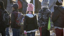 LUKEVILLE, ARIZONA - DECEMBER 07: Ecuadorian immigrant children await transport from the U.S.-Mexico border on December 07, 2023 in Lukeville, Arizona. A surge of immigrants illegally ing through openings cut by smugglers in the border wall has overwhelmed U.S. immigration authorities, causing them to shut down several international ports of entry so that officers can help process the new arrivals. (Photo by John Moore/Getty Images)