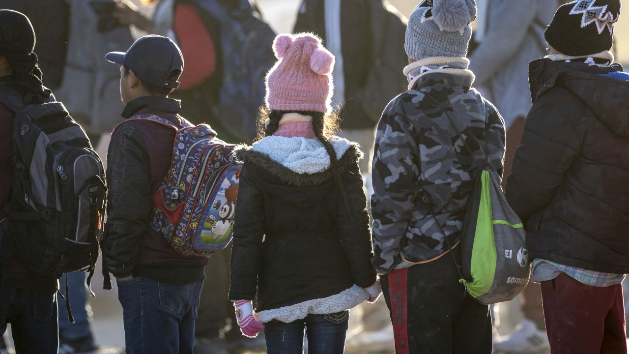 LUKEVILLE, ARIZONA - DECEMBER 07: Ecuadorian immigrant children await transport from the U.S.-Mexico border on December 07, 2023 in Lukeville, Arizona. A surge of immigrants illegally ing through openings cut by smugglers in the border wall has overwhelmed U.S. immigration authorities, causing them to shut down several international ports of entry so that officers can help process the new arrivals. (Photo by John Moore/Getty Images)