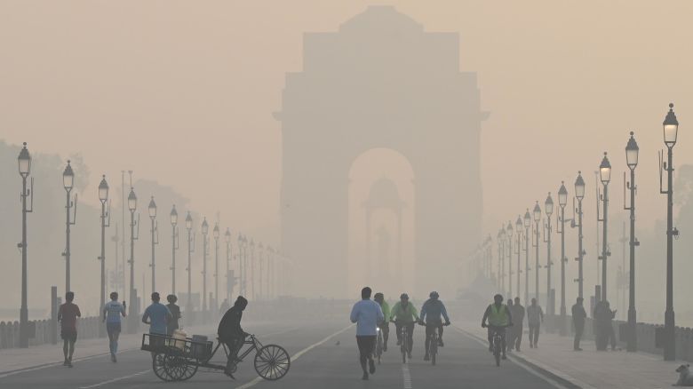 Morning walkers seen during a cold and hazy morning at Kartavya Path near India Gate on December 9, 2023 in New Delhi, India.
