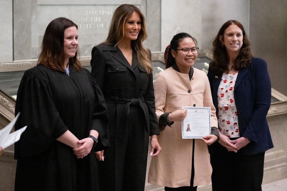 Former first lady Melania Trump stands alongside Judge Elizabeth Gunn, left, and Archivist of the US Colleen Shogan, far right, as they pose for photographs with a newly-sworn in citizens following a Naturalization Ceremony at the National Archives in Washington, DC, December 15.