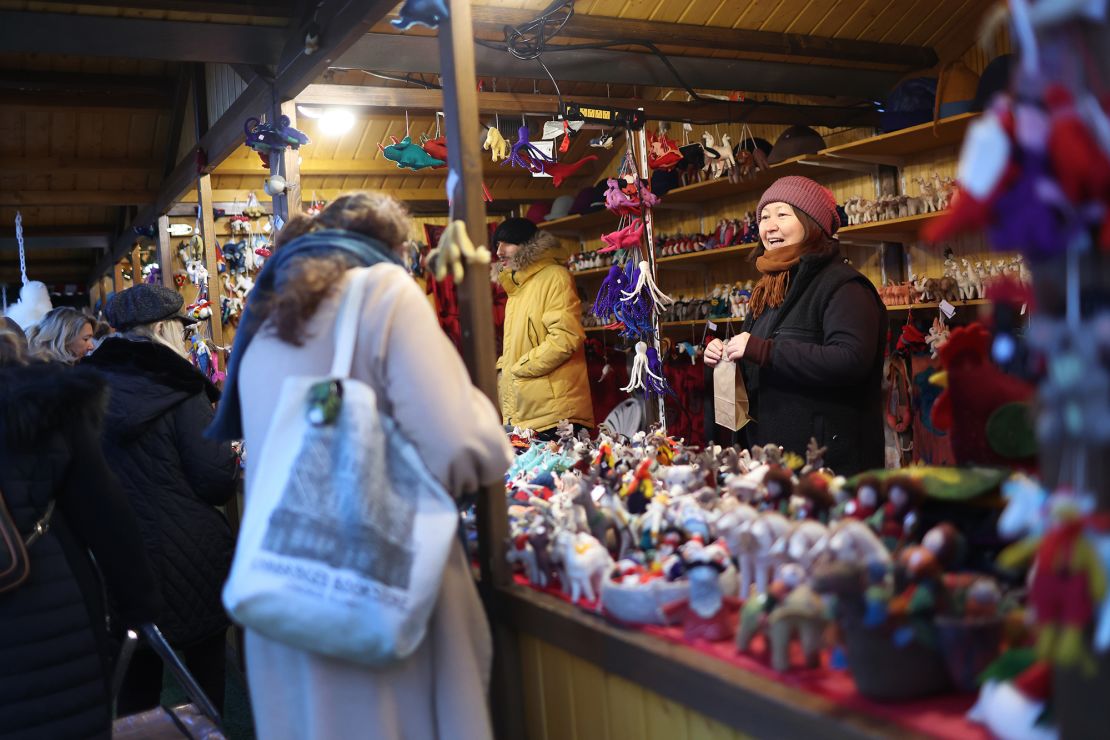 People shop for holiday items at the Christkindlmarket outside of Wrigley Field on December 12, 2023 in Chicago.