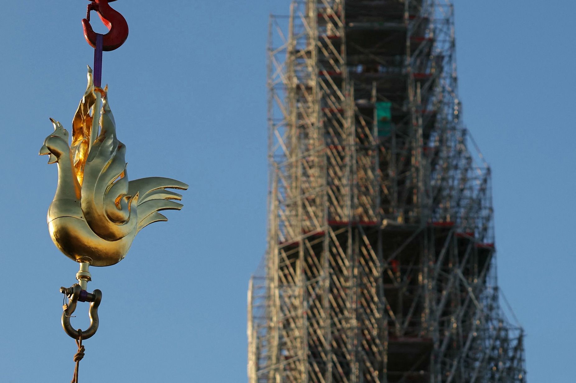 The new golden rooster, designed by architect Philippe Villeneuve, contains relics saved from the fire that struck the monument on April 15, 2019, and a document with the names of those working on its reconstruction.