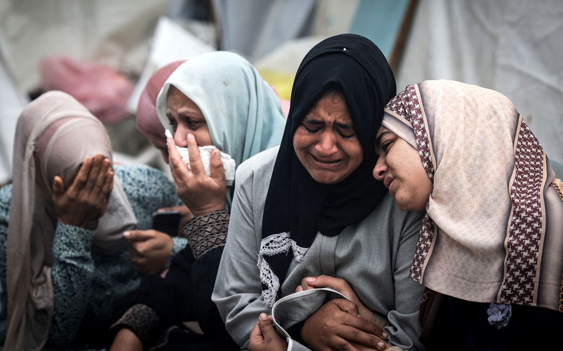 palestinians mourn their relatives, killed in an israeli strike on the al-maghazi refugee camp, during a mass funeral at the al-aqsa hospital in deir al-balah, in the central gaza strip, on december 25, 2023.