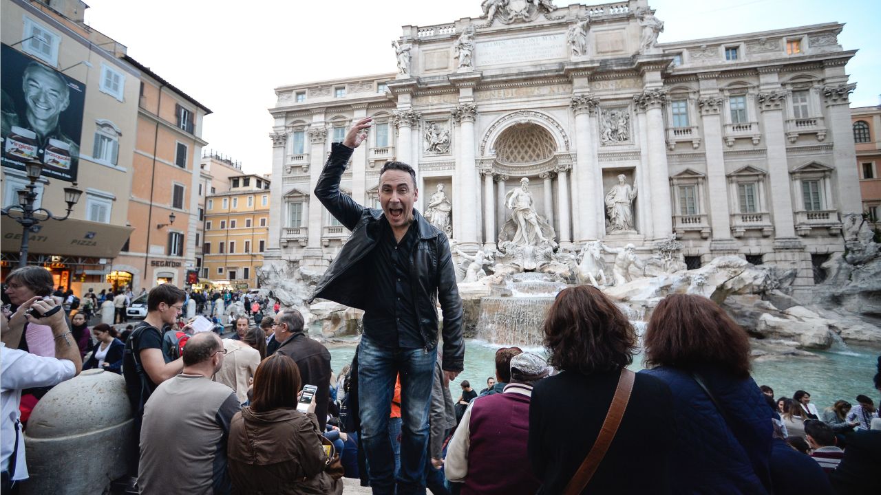 TO GO WITH AFP STORY BY EMMANUEL BARRANGUET
French comic strip writer Thierry Terrasson, also known as Jim, makes a wish as he throws a coin in the water of the Trevi Fountain on November 4, 2013, in central Rome. The 47 year old author presents his new comic strip "A night in Rome" which tells a story about two former lovers who decide to hold on a 20 year old promise. AFP PHOTO / ANDREAS SOLARO (Photo by Andreas SOLARO / AFP) (Photo by ANDREAS SOLARO/AFP via Getty Images)