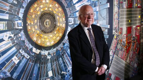 LONDON, ENGLAND - NOVEMBER 12:  Professor Peter Higgs stands in front of a photograph of the Large Hadron Collider at the  Science Museum's 'Collider' exhibition on November 12, 2013 in London, England. At the exhibition, which opens to the public on November 13, 2013  visitors will see a theatre, video and sound art installation and artefacts from the Large Hadron Collider, providing a behind-the-scenes look at the CERN particle physics laboratory in Geneva. It touches on the discovery of the Higgs boson, or God particle, the realisation of scientist Peter Higgs theory.  (Photo by Peter Macdiarmid/Getty Images)