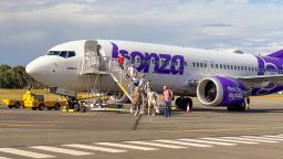 Passengers disembark a Bonza plane in December 2023.