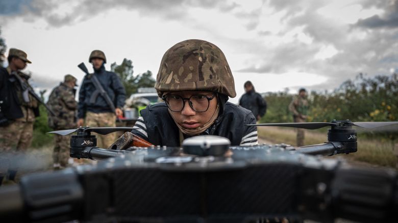 A member of the Mandalay People's Defense Forces (MDY-PDF) preparing to release a drone near the frontline amid clashes with Myanmar's military in northern Shan State. A squad of Myanmar pro-democracy fighters works quickly to ready drones for an attack on a nearby military base, the latest target in a wave of aerial assaults that has helped turn the war against the junta, in Myanmar, on December 11, 2023.