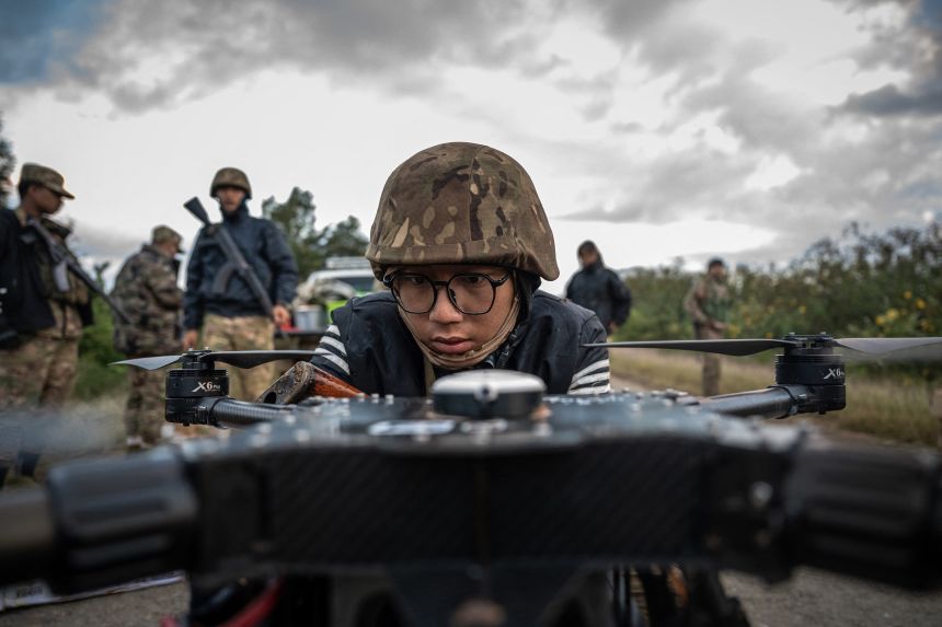 A member of the Mandalay People's Defense Forces preparing to release a drone near the front line amid clashes with Myanmar's military in northern Shan State.