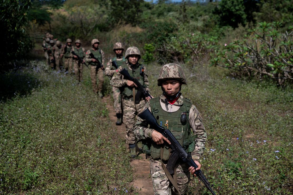 Members of the Mandalay People's Defense Forces (MDY-PDF) patrol near the front line amid clashes with Myanmar's military in northern Shan State on December 10, 2023.