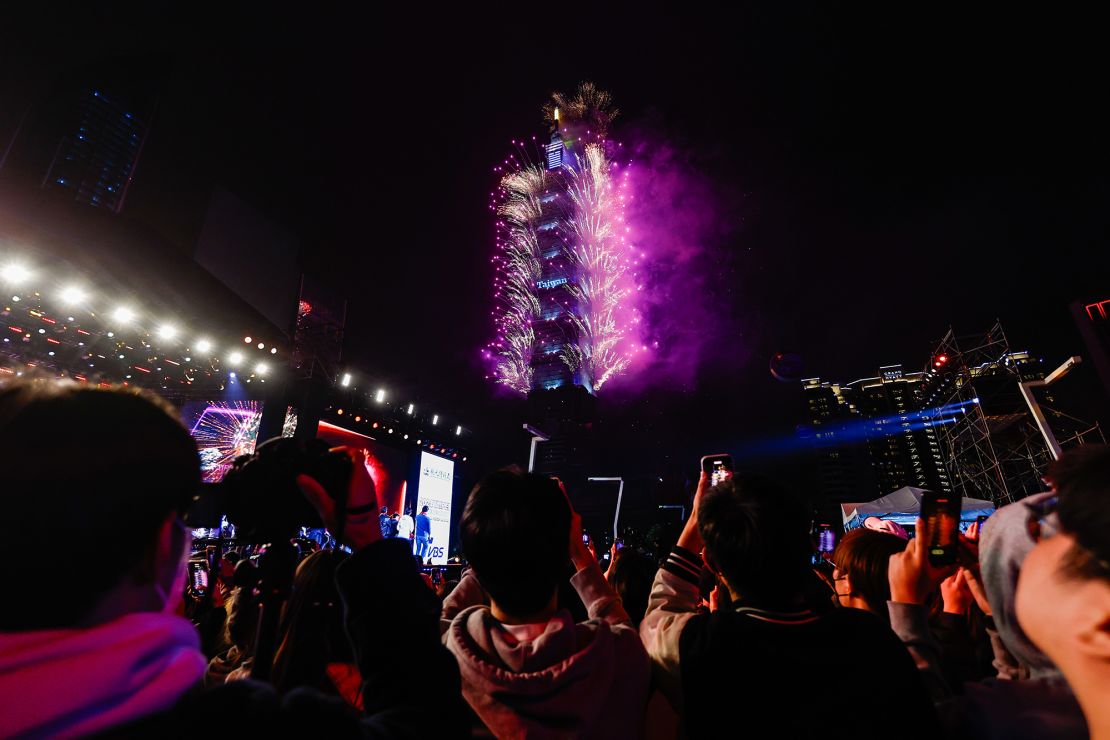 People watch fireworks being released from the Taipei 101 building in Taipei, Taiwan, to ring in 2024.