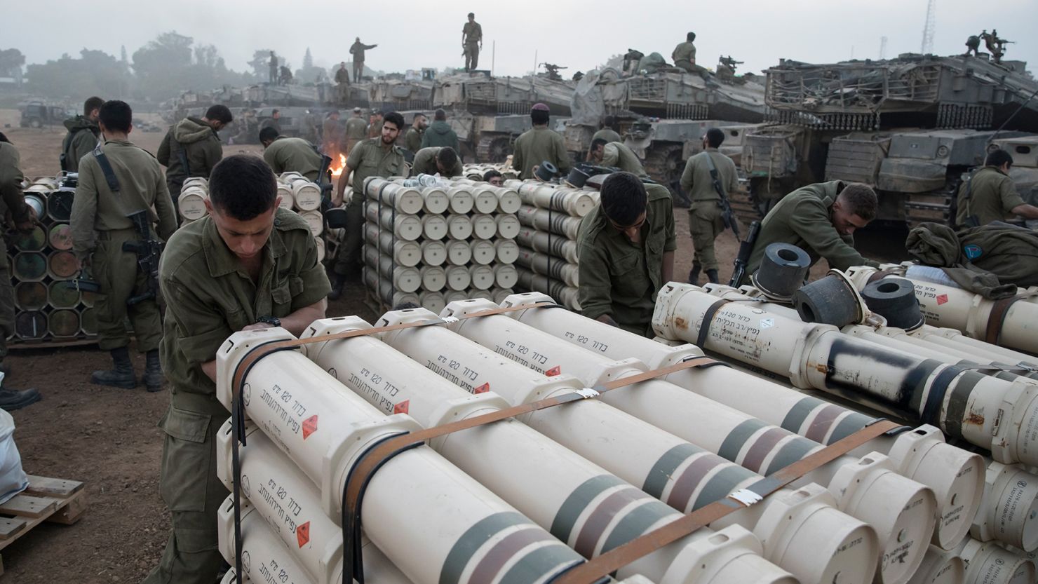 Israeli soldiers organize tank shells after returning from the Gaza Strip on January 1, at Israel's southern border.