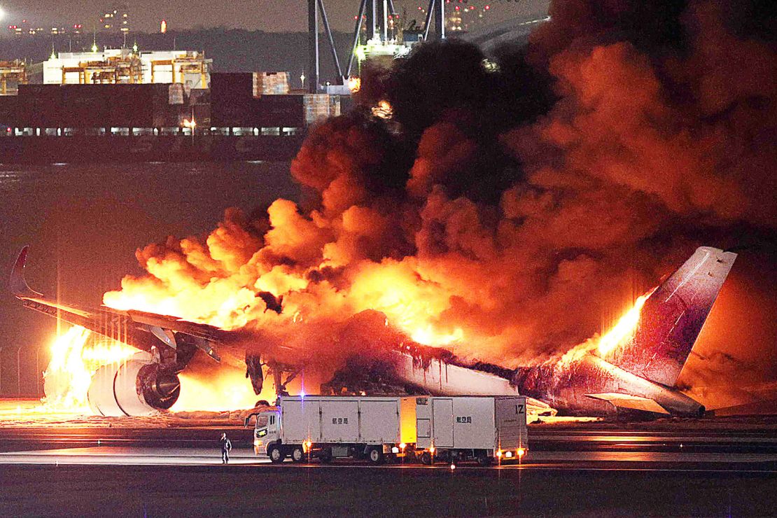 The Japan Airlines plane is gutted by fire on a runway of Tokyo's Haneda Airport on January 2, 2024.