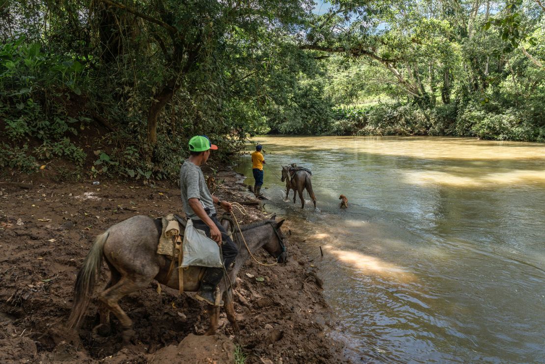 Residents ride horses to cross the Río Indio in the town of El Limón in Chagres district, Colón, Panama, on Tuesday, November 21, 2023.