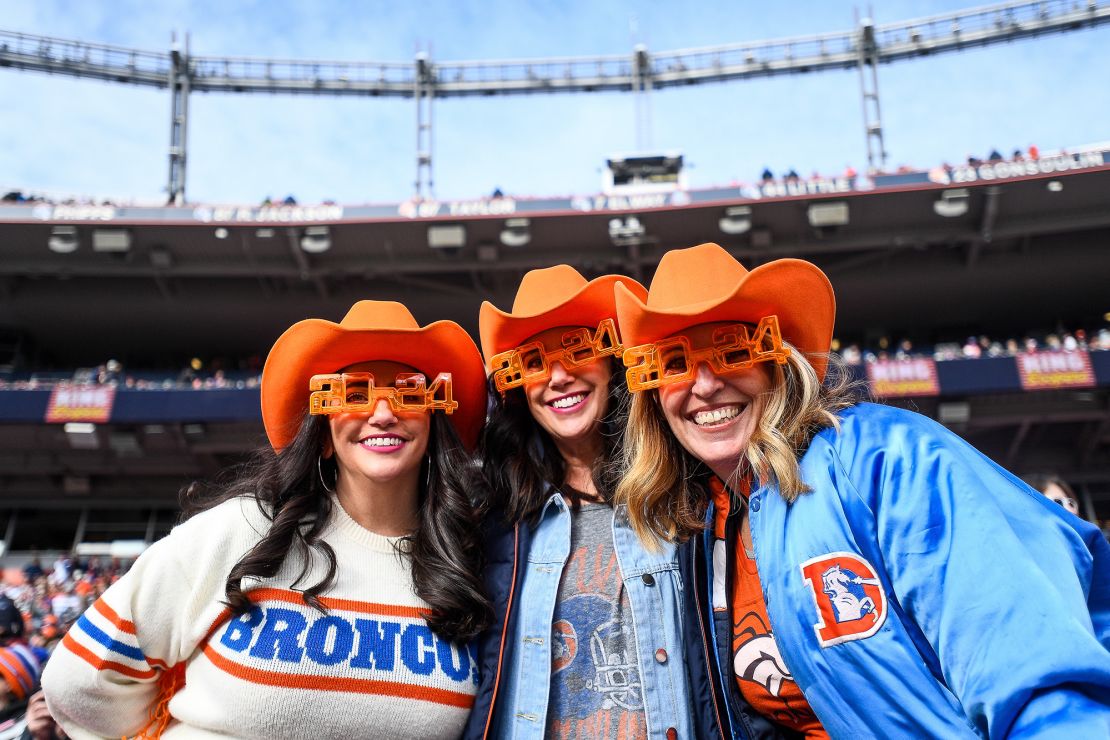 Denver Broncos fans dressed with colorful costumes and New Years Eve flair as they watch a game between the Denver Broncos and the Los Angeles Chargers at Empower Field at Mile High on December 31, 2023 in Denver, Colorado.