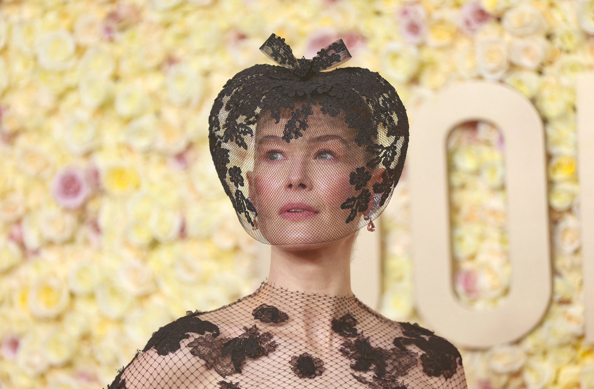 'Saltburn” actress Rosamund Pike’s decision to match her lacy black Fall 2019 Dior couture dress with a veiled fascinator by Philip Treacy came about following a recent skiing accident. 'My face was entirely smashed up and I thought, 'I need to do something',” she told the red carpet pre-show presenter Marc Malkin. “Actually, it's healed, but I fell in love with the look.”