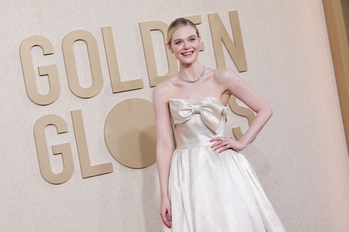 Elle Fanning went for a simple cream vintage Pierre Balmain with an oversized bow bodice detail, Cartier jewels and sleek updo.