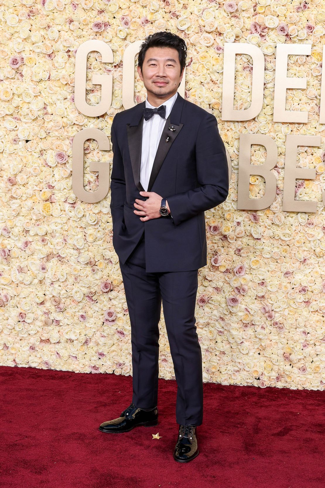 “Barbie” actor Simu Liu wore a navy-blue Givenchy jacket and matching trousers, a white cotton poplin shirt and a black silk satin bow tie.