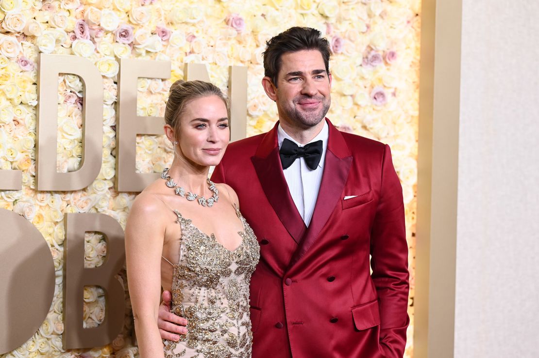 “Oppenheimer” star Emily Blunt wore a gold and white tulle Alexander McQueen dress with Tiffany & Co. jewelry, while husband John Krasinski looked bold in a red satin blazer and burgundy trousers by Dolce & Gabbana.