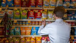 A worker arranges Lay's chips at a Safeway grocery store in Scottsdale, Arizona, on Wednesday, January 3.