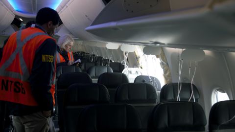 Members of the NTSB examine the hole in the fuselage plug area of Alaska Airlines Flight 1282 shortly after the flight.