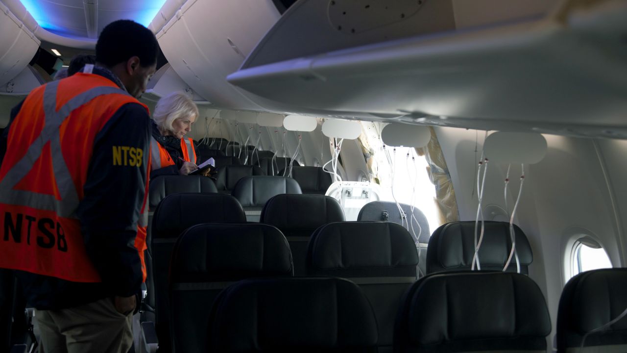 PORTLAND, OREGON - JANUARY 7: In this National Transportation Safety Board (NTSB) handout, members of the NTSB examine the hole in the fuselage plug area of Alaska Airlines Flight 1282 Boeing 737-9 MAX on January 7, 2024 in Portland, Oregon. A door-sized section near the rear of the Boeing 737-9 MAX plane blew off 10 minutes after Alaska Airlines Flight 1282 took off from Portland, Oregon on January 5 on its way to Ontario, California.  (Photo by NTSB via Getty Images)