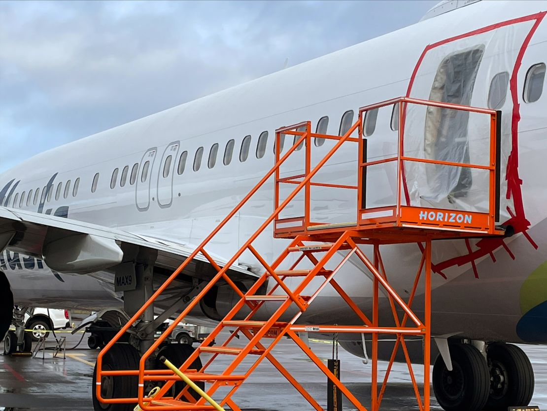 Plastic covers the exterior of the fuselage plug area of Alaska Airlines Boeing 737 Max 9 where a door plug on the plane blew off on a January 5 flight. The incident has sparked new focus on problems with the safety and quality controls at Boeing.