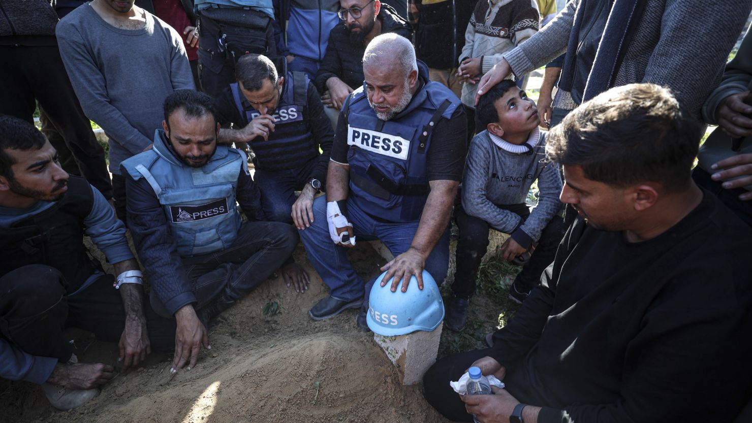 A Press helmet is placed over the grave of Hamza Dahdouh, a Palestinian journalist who worked for Al Jazeera and was killed in an Israeli air strike on Rafah.