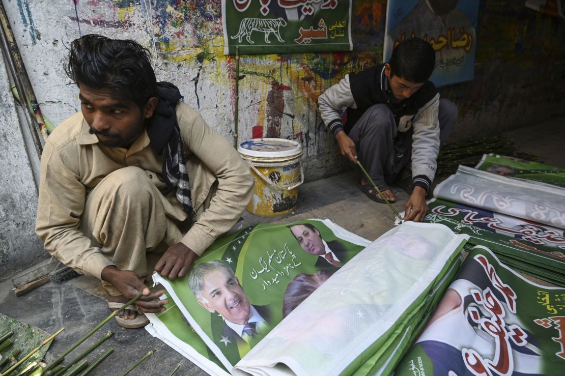 Workers prepare election campaign posters of the Pakistan Muslim League (N) party in Rawalpindi on January 10, 2024.