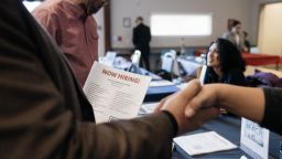 Attendees shake hands at a Veteran Employment and Resource Fair in Long Beach, California, US, on Tuesday, Jan. 9, 2024.