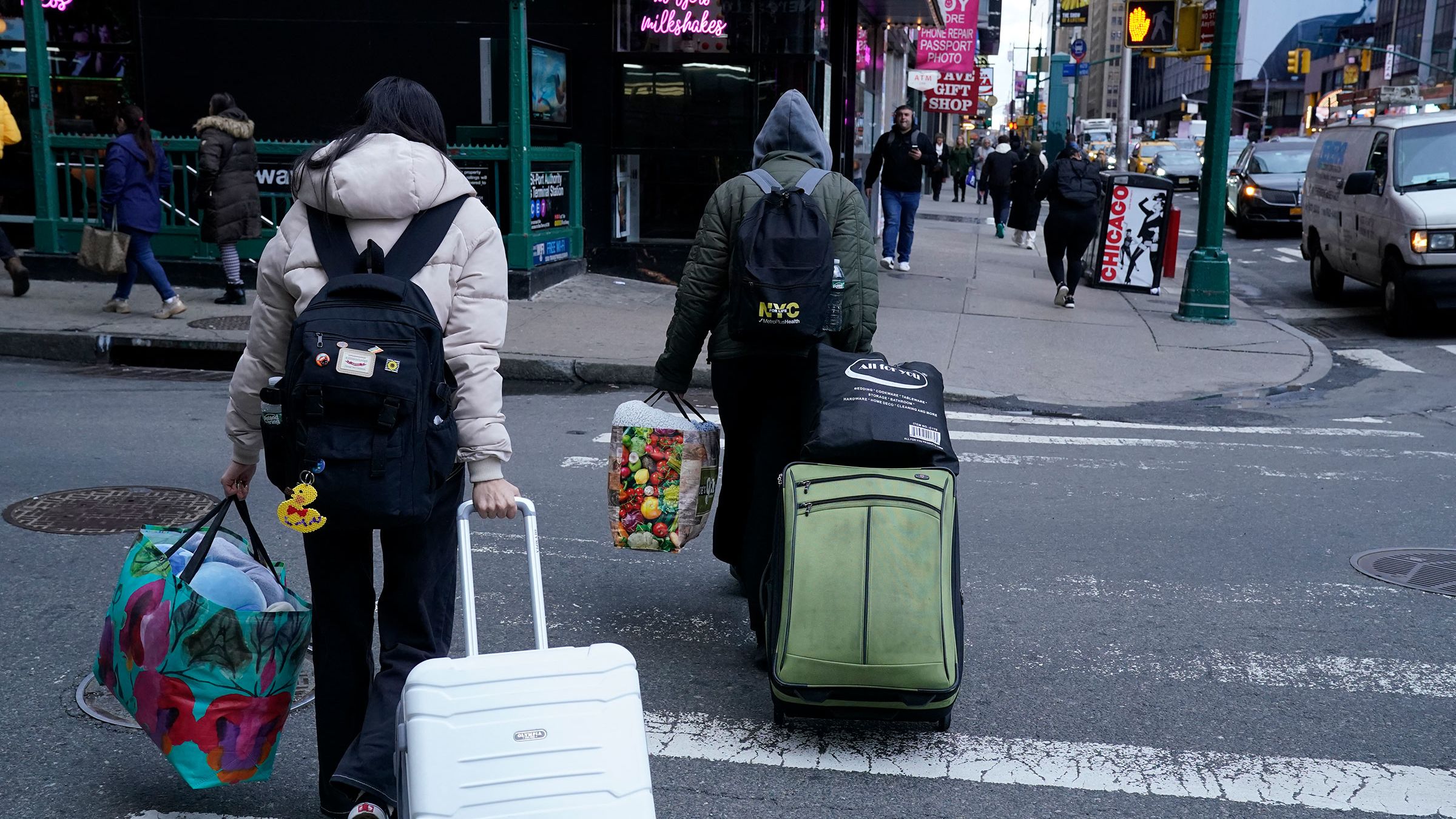 A migrant family leaves the Row Hotel in midtown Manhattan January 10, 2024.