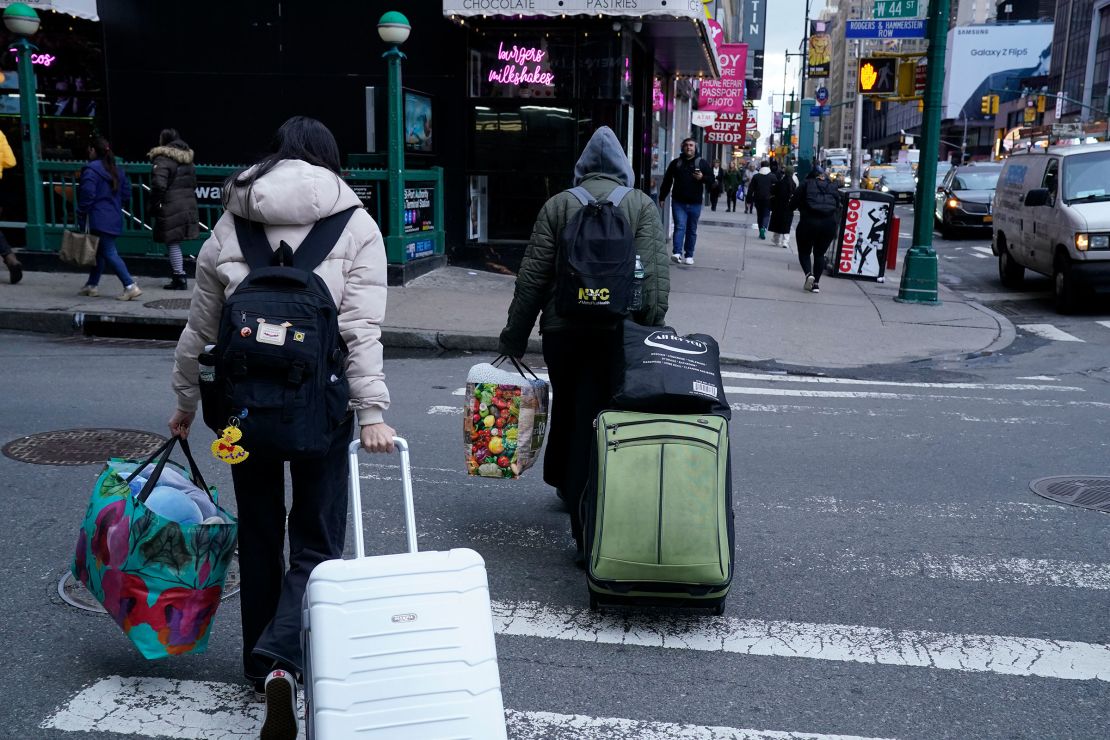 A migrant family leaves the Row Hotel in midtown Manhattan January 10, 2024.